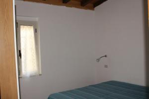 a bedroom with a bed and a window at Citrigni in Peschici