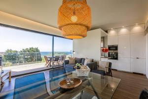 a living room with a view of the ocean at Quinta das Camélias - Açores in Ponta Delgada