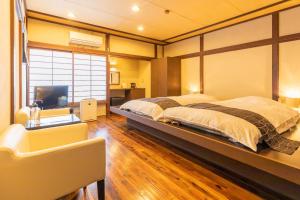 Una cama o camas en una habitación de Ryokan Hiyoshi