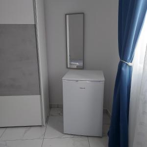 a white refrigerator in a room with a mirror at CASA GRIMA - private double room in Birkirkara