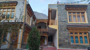 a group of buildings with a mountain in the background at Himalayan Regal House in Deskit