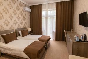 Llit o llits en una habitació de Hirkan Park Hotel