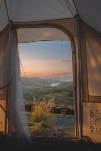 a view from inside a tent with a view of the mountains at Papa Garden Khaokho in Khao Kho