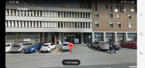 a parking lot with cars parked in front of a building at Infinity Collection in Padova