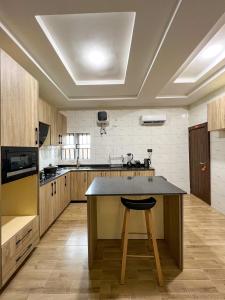 a large kitchen with a island in the middle at Sparkles Apartments in Abuja
