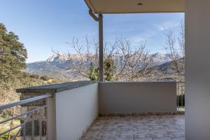 a balcony with a view of the mountains at orminia house upper level 