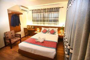 Rúm í herbergi á Hotel Amaryllis Kathmandu
