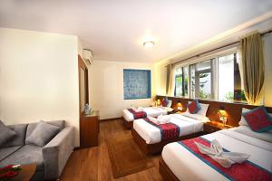Rúm í herbergi á Hotel Amaryllis Kathmandu