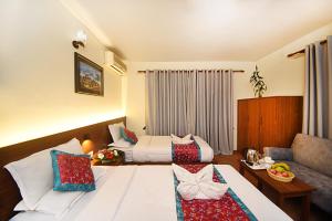 Rúm í herbergi á Hotel Amaryllis Kathmandu