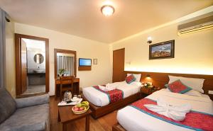 Rúm í herbergi á Hotel Amaryllis Kathmandu