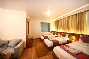 Rúm í herbergi á Hotel Amaryllis Kathmandu
