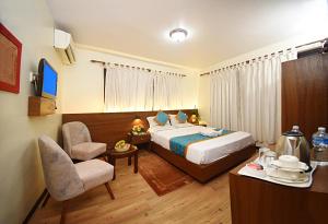 Rúm í herbergi á Hotel Amaryllis Kathmandu