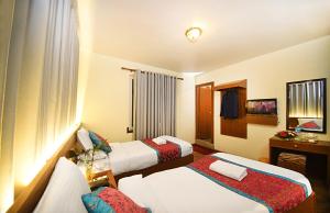Rúm í herbergi á Hotel Amaryllis Kathmandu