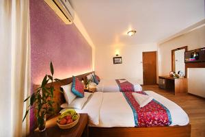Rúm í herbergi á Hotel Amaryllis Kathmandu