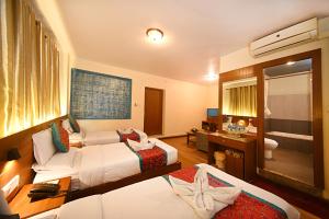Rúm í herbergi á Hotel Amaryllis Kathmandu