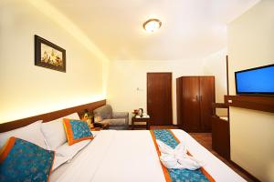 Rúm í herbergi á Hotel Amaryllis Kathmandu