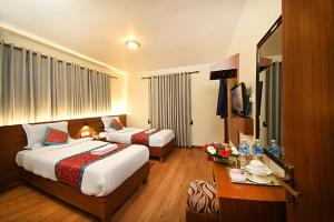 Rúm í herbergi á Hotel Amaryllis Kathmandu