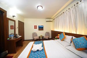 Rúm í herbergi á Hotel Amaryllis Kathmandu