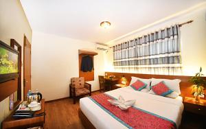 Rúm í herbergi á Hotel Amaryllis Kathmandu