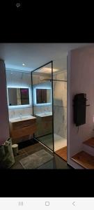 a bathroom with two sinks and a mirror at Romantique room in Charleville-Mézières