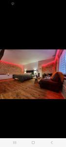 a living room with a couch and a chair at Romantique room in Charleville-Mézières +4 photos