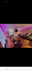 a bedroom with two beds and purple lights at Romantique room in Charleville-Mézières