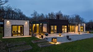 a modern house with lights on the grass at Palivor Çiftliği in Korfo