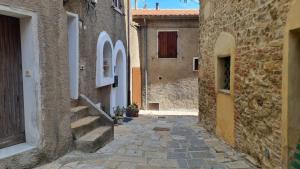 un callejón en un casco antiguo con edificios de piedra en Casa Laura: Toscana per sempre!, en Cinigiano
