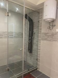 a shower with a glass door in a bathroom at Appartment Anjou in Casablanca
