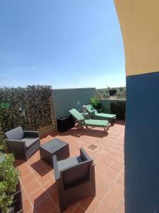 a patio with chairs and tables on a patio at LOS PEPINOS ( mi lugar favorito ) in Zamora