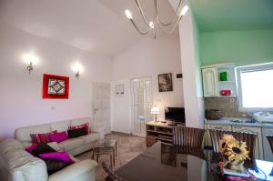 a living room with a couch and a table at Villa Danijela with heated pool,jacuzzi and sauna in Seget Vranjica