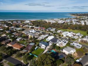 an aerial view of a town with houses and the ocean at Fun Filled Renovated 80's Gem, 400m to Beach! in Torquay