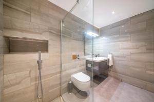 a bathroom with a toilet and a glass shower at *RC7C* For your most relaxed & Cosy stay + Free Parking + Free Fast WiFi * in Batley