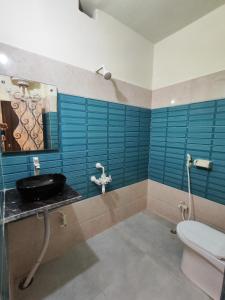a bathroom with a sink and a toilet and a mirror at Sunrise Homestay Agra Near Taj Mahal in Agra +76 photos