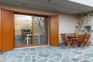 a patio with a table and chairs on a patio at Orminia ground level 