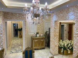 a living room with a chandelier and a hallway at LuXury Apartment Agouza-Mohandesin in Cairo