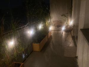 a patio with plants and lights at night at Przestronny apartament na Dolnej in Warsaw +26 photos