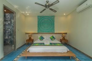 a bedroom with a bed and a ceiling fan at Sari Dana Villas in Sanur +22 photos