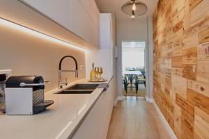 a kitchen with a sink and a counter top at Apartament Emiliya in Pomorie