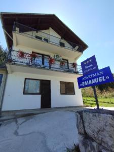 a building with a sign in front of it at Apartman Emanuel in Jajce