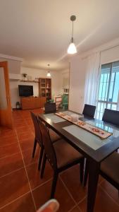 a living room with a dining table and chairs at Vaca House in El Puerto de Santa María