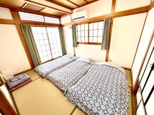 una camera con due letti in una stanza con finestre di 浜町小院别馆 a Takamatsu