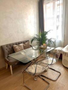 a living room with a glass table and a couch at Appartment. Quiet&Nice downtown in Oslo