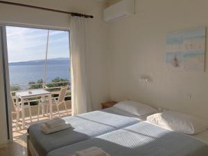 A bed or beds in a room at Galini Studios and Apartments