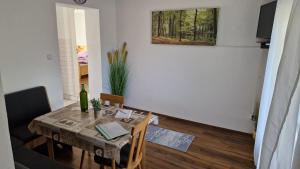 a dining room table with a bottle of wine on it at Ferienwohnung Mostheuriger Leo-Hof Kathi in Hirschwang