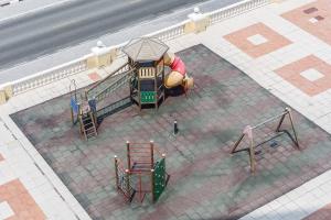 an aerial view of a playground on a sidewalk at Budget Friendly & Studio & Golf View in Ras al Khaimah
