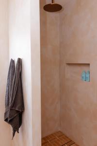 a shower with a towel hanging on a wall at Heights Guesthouse - Hideaway in Kiama Heights in Kiama
