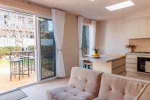 a kitchen and living room with a couch and a table at Heights Guesthouse - Hideaway in Kiama Heights in Kiama