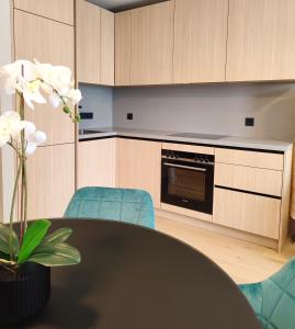 a kitchen with a black table and blue chairs at Design Apartment Vienna City Center - free parking! in Vienna