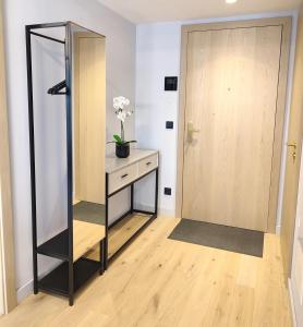 a dressing room with a mirror next to a door at Design Apartment Vienna City Center - free parking! in Vienna